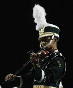 Tony Swope performs with the marching band during half time.