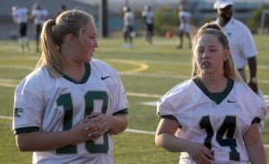 Team managers senior Shelby Kelley and prepare for the game to start. "I love football so why not spend an entire fall season with a sport that I love?" Kelley said. This is her third year managing the football team.