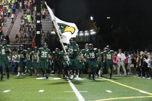 Senior Jacob Reese carries the flag and leads MV onto the field two minutes before the start of the second half.