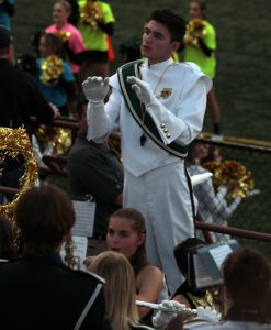 Rushall conducts the band in the stands.