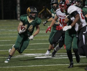 Michael Rizzo 14, rushes for a first down. Photo by Tyler Merchant.