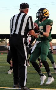 Dean hands the ball of to the referee after scoring the first home touchdown of the season.