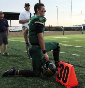 Erickson kneels while watching MV's defense hold back RV's offense.